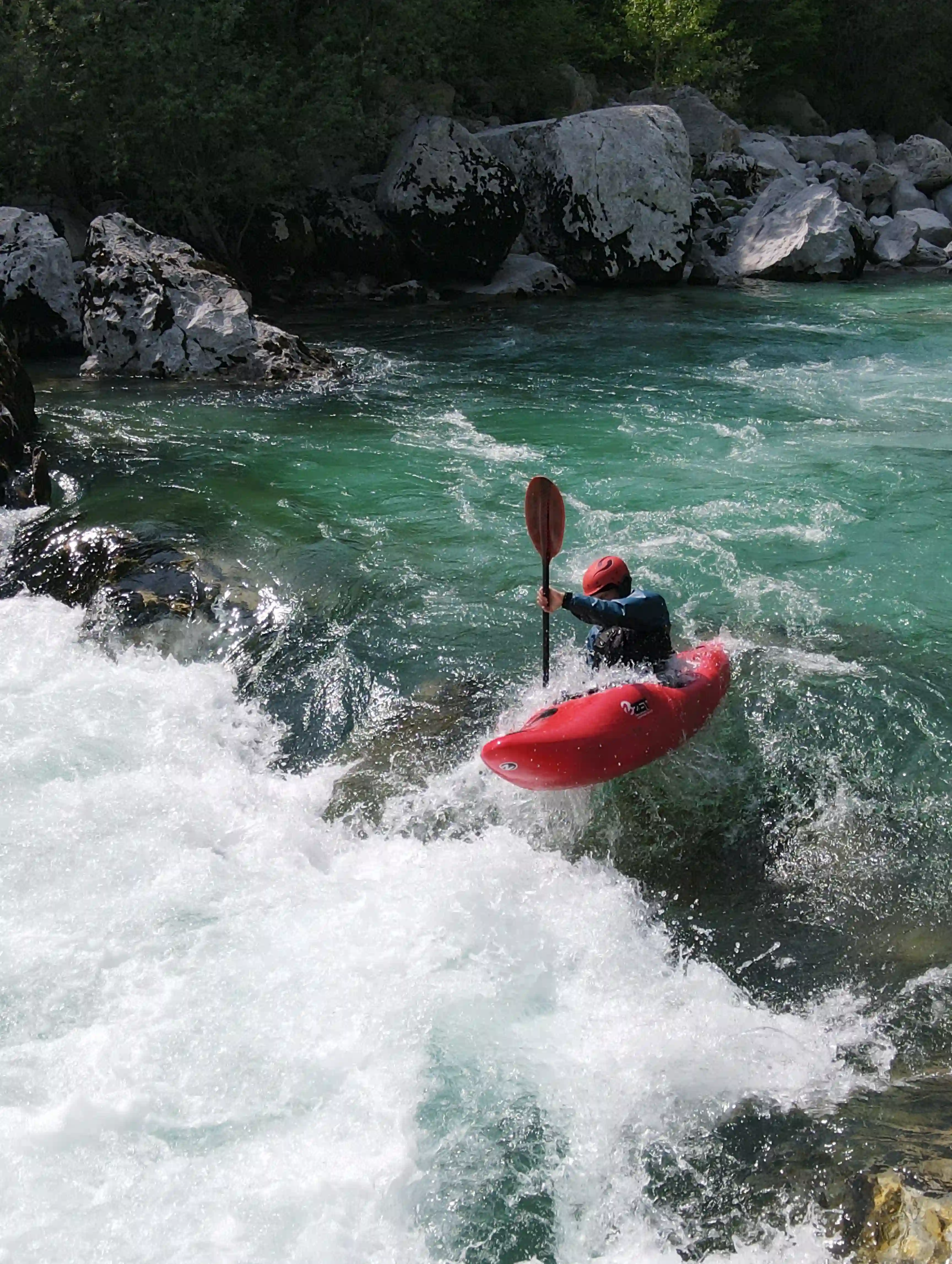 Kayaker boofing on the Slalom section Soca