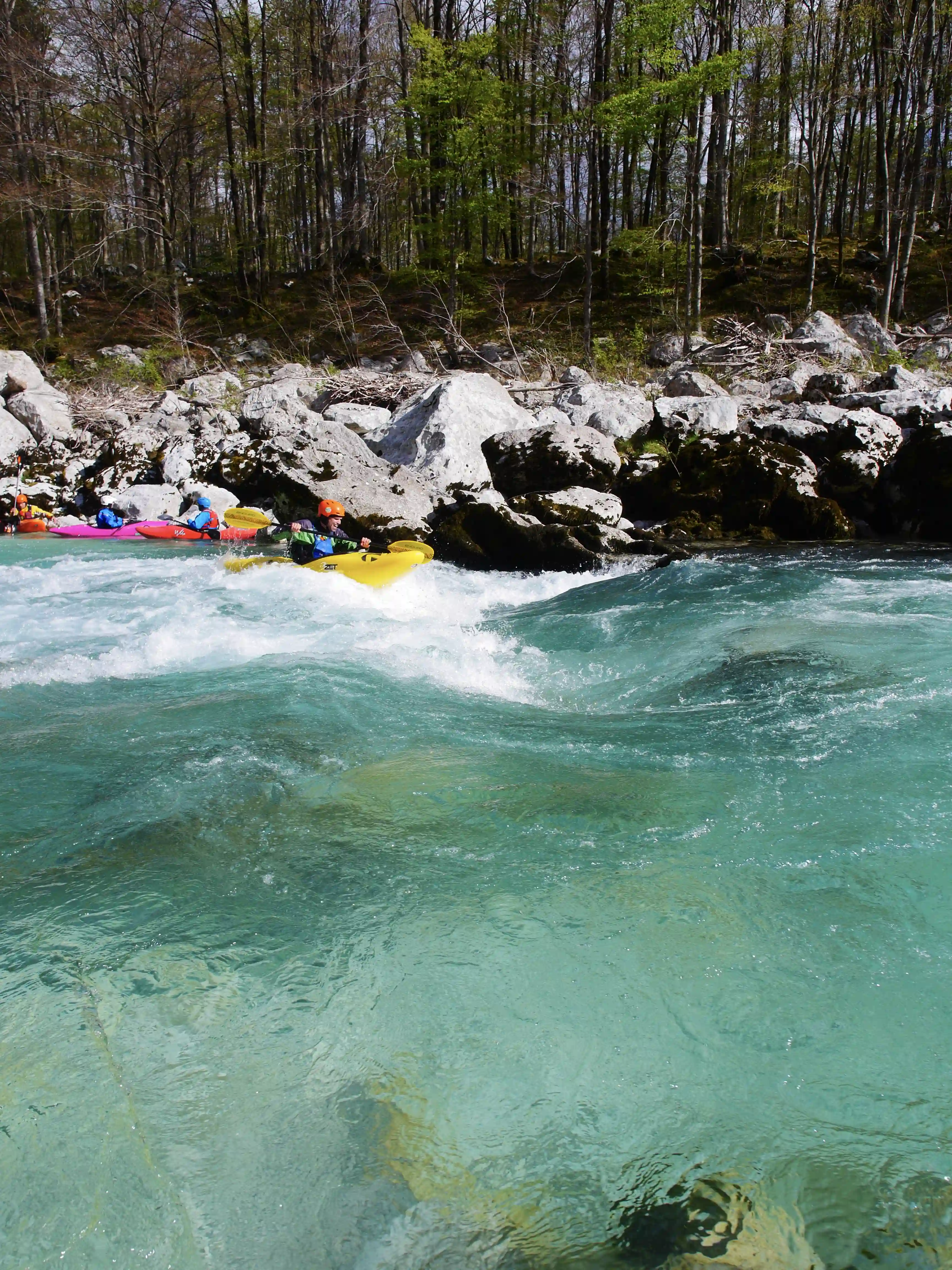 Surfing kayaker on a blue river